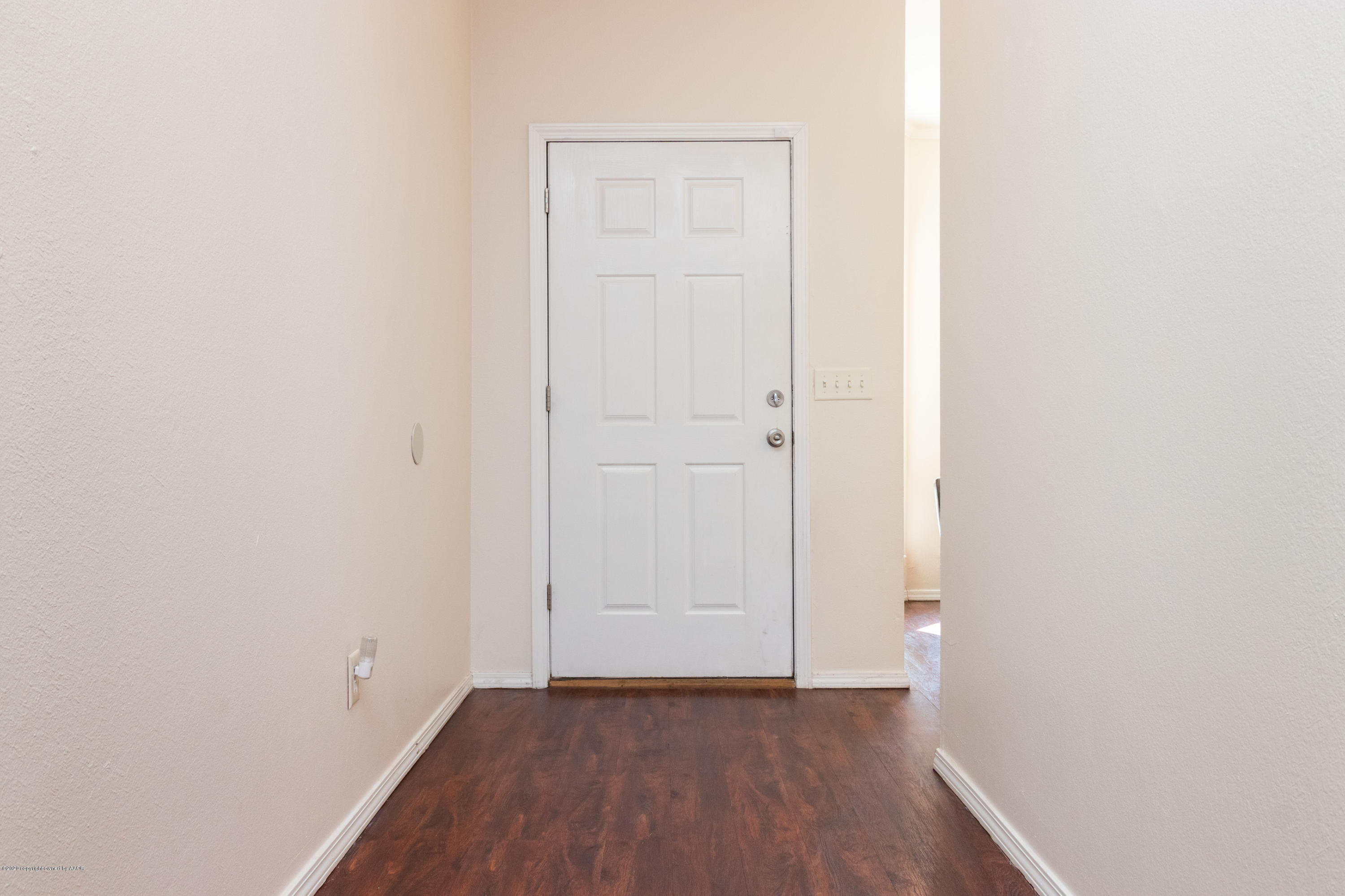 5203 Capulin Lane Amarillo, TX 79110 - Photo 4 of 29 a view of an empty room with wooden floor