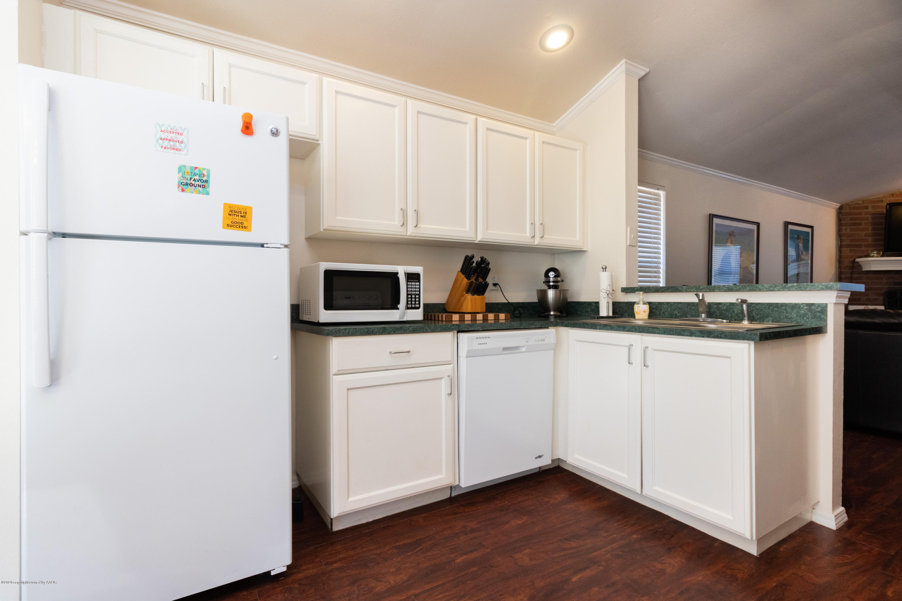 5203 Capulin Lane Amarillo, TX 79110 - Photo 7 of 29 a kitchen with stainless steel appliances white cabinets and a refrigerator