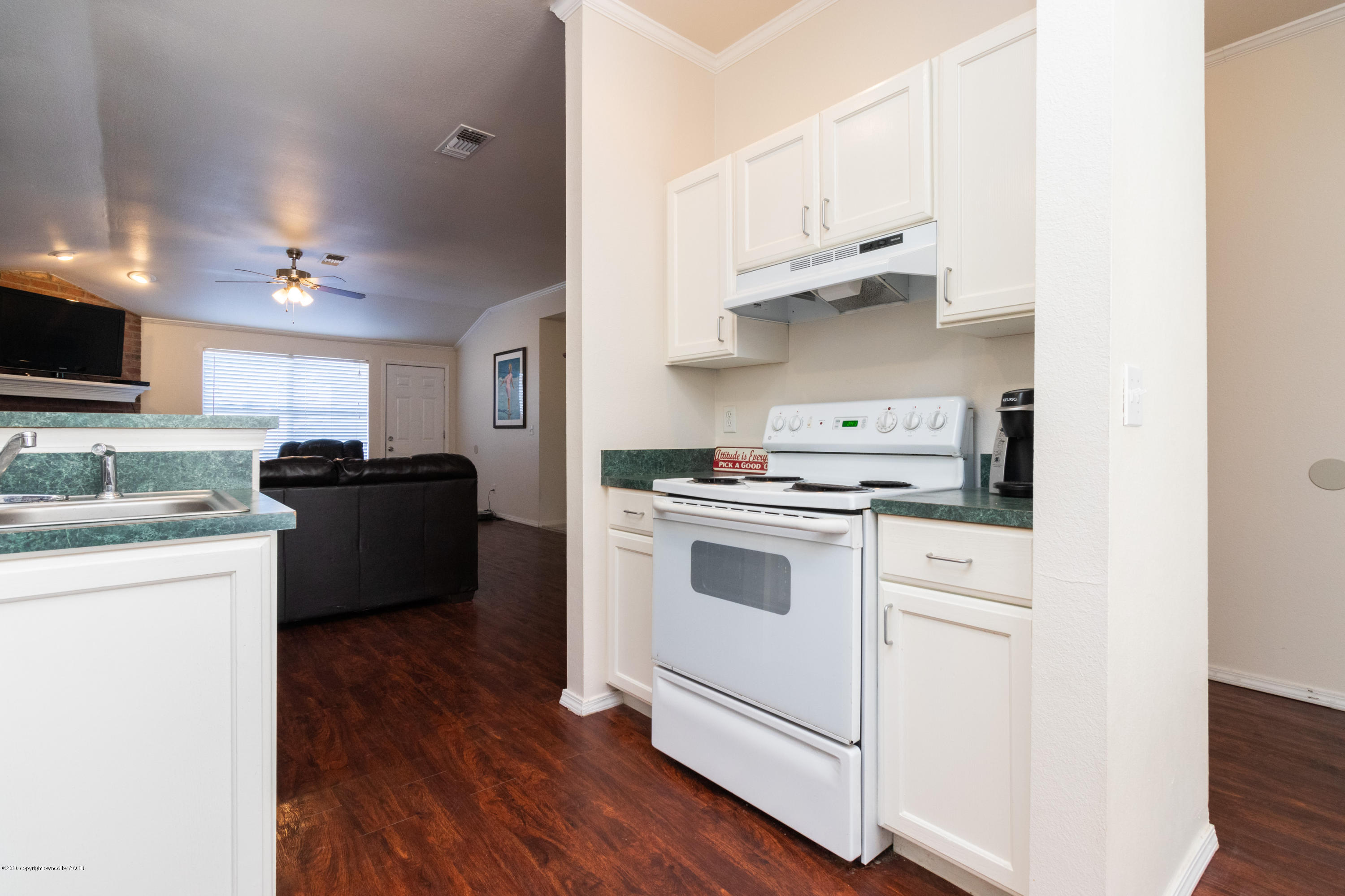 5203 Capulin Lane Amarillo, TX 79110 - Photo 8 of 29 a kitchen with granite countertop white cabinets and appliances