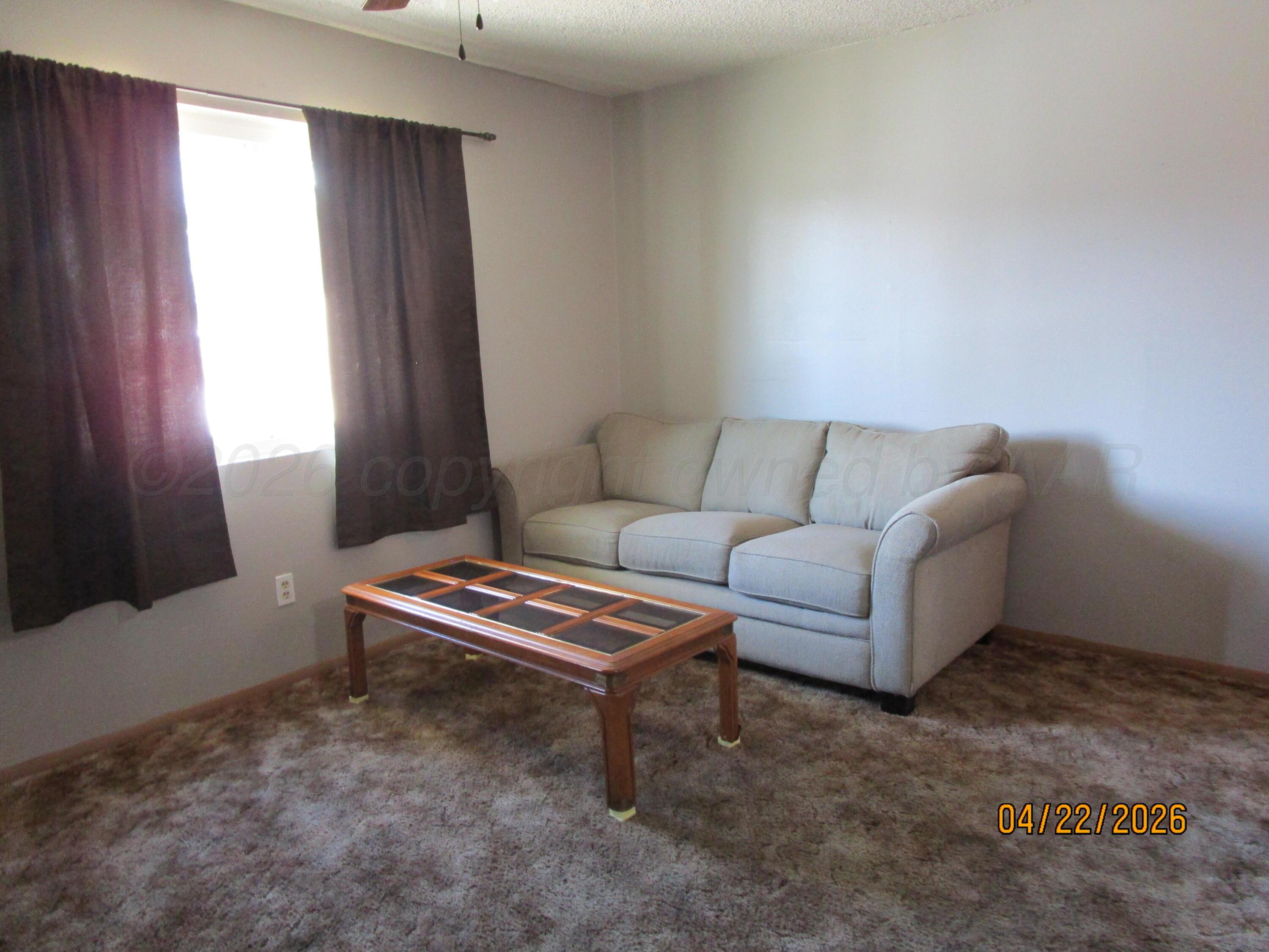 720 Deahl Street Borger, TX 79007 - Photo 2 of 5 a living room with furniture and a window
