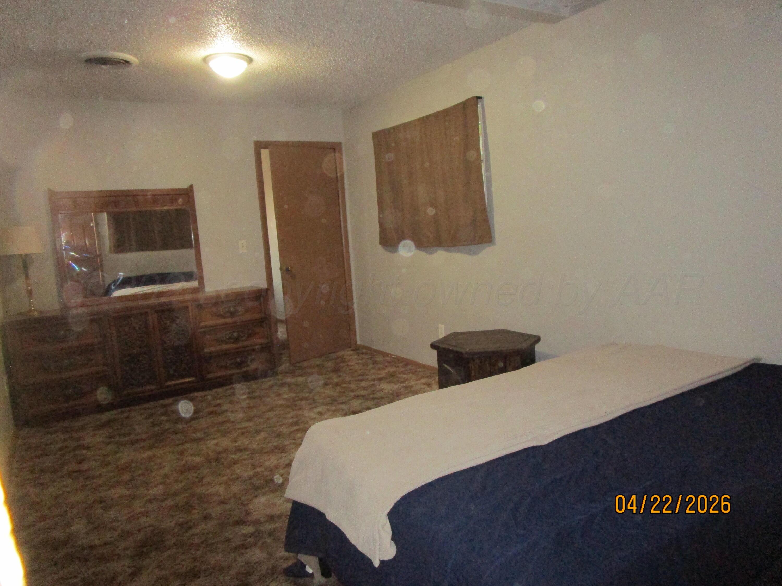 720 Deahl Street Borger, TX 79007 - Photo 4 of 5 a bedroom with a bed and a dresser