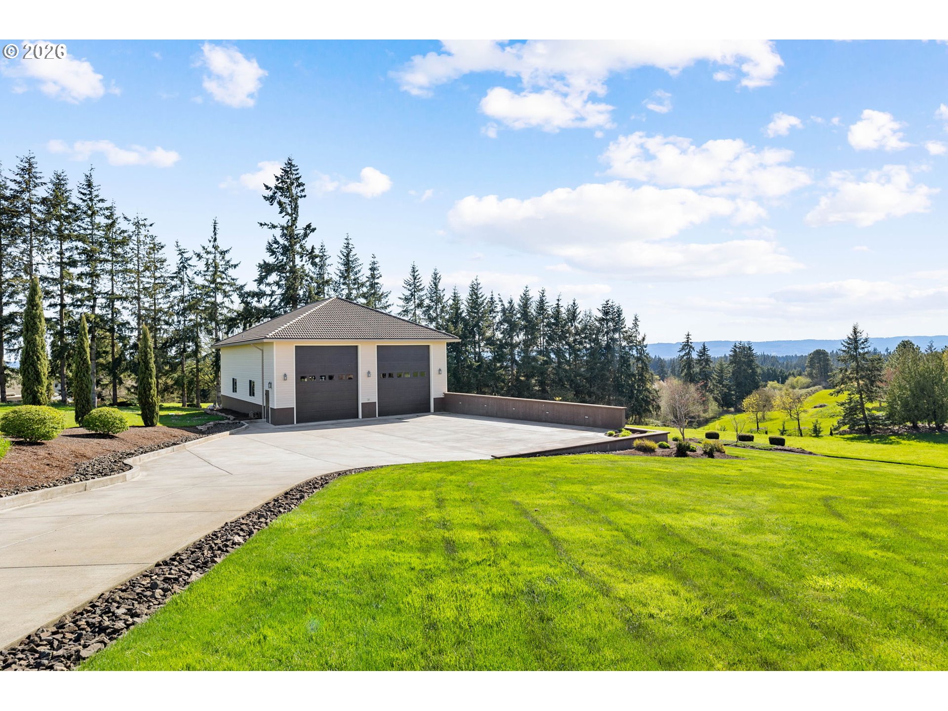 1911 Northwest 206th Street Ridgefield, WA 98642 - Photo 30 of 31 a view of a house with a big yard and large trees