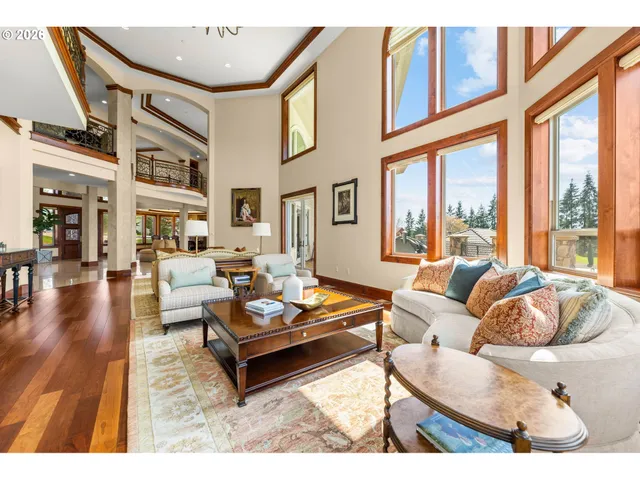 a living room with furniture fireplace and a large window