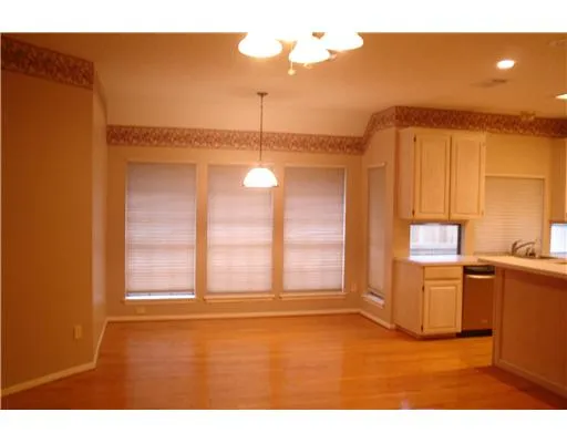 a view of a kitchen with a sink and cabinet with wooden floor