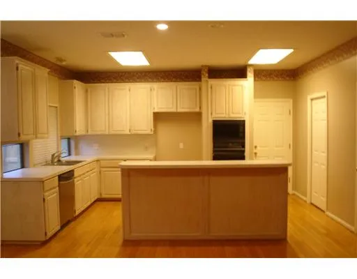 a kitchen with stainless steel appliances granite countertop a sink and a refrigerator