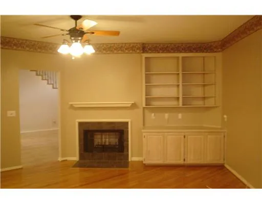a view of a livingroom with a fireplace and a chandelier
