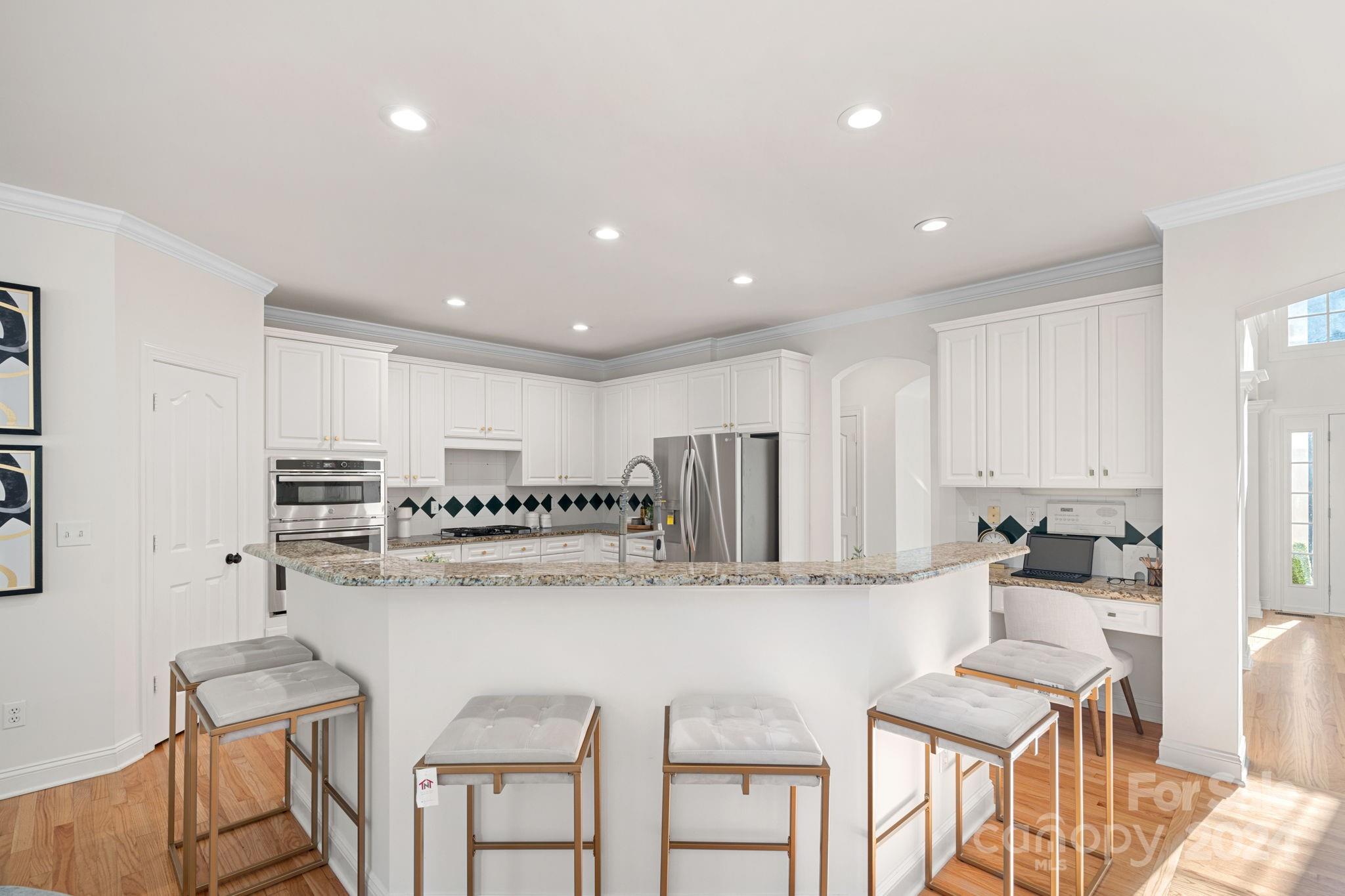 3425 Rhett Butler Place Charlotte, NC 28270 - Photo 12 of 48 a kitchen with cabinets and chairs