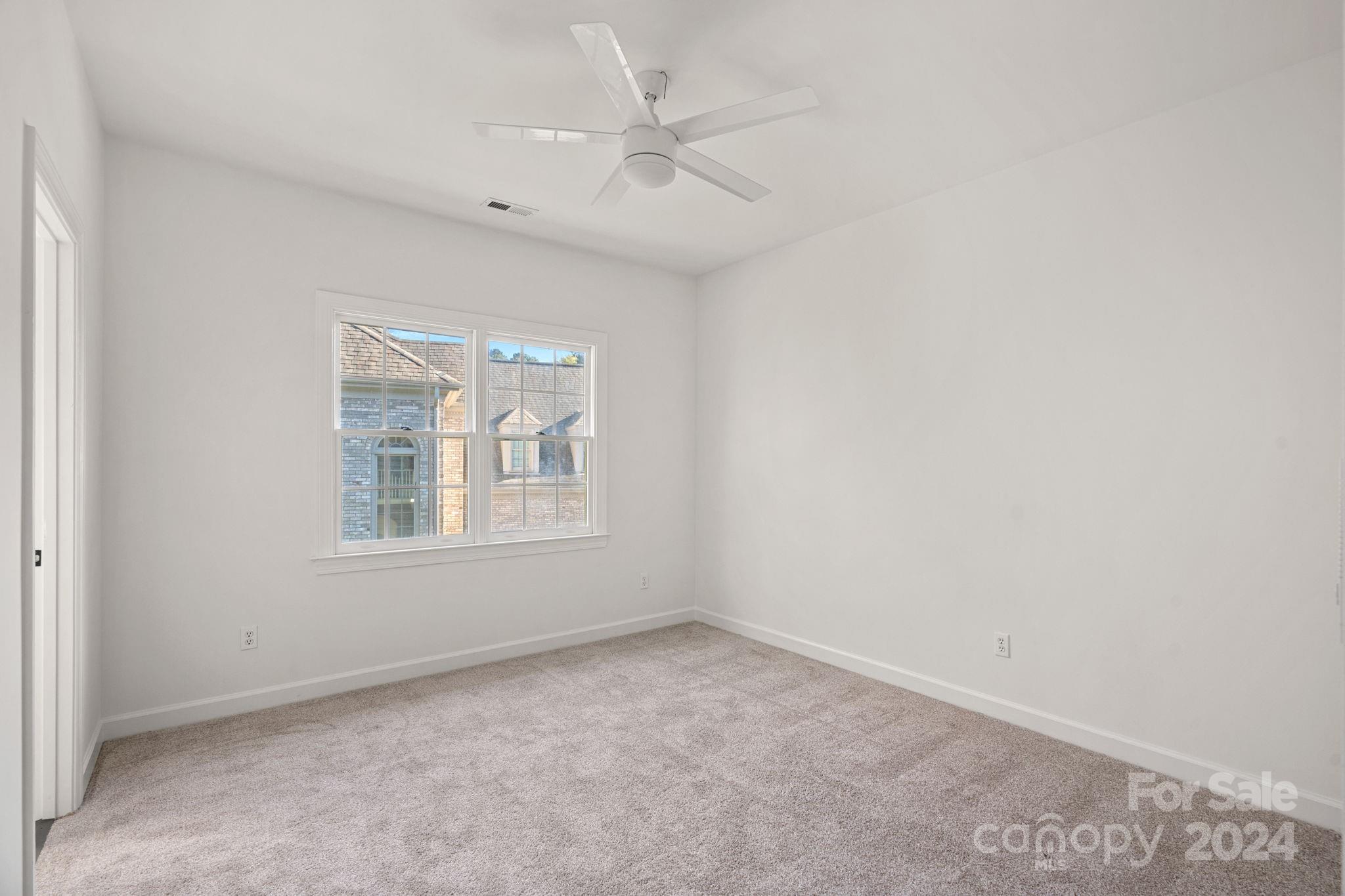 3425 Rhett Butler Place Charlotte, NC 28270 - Photo 28 of 48 an empty room with a window and a fan