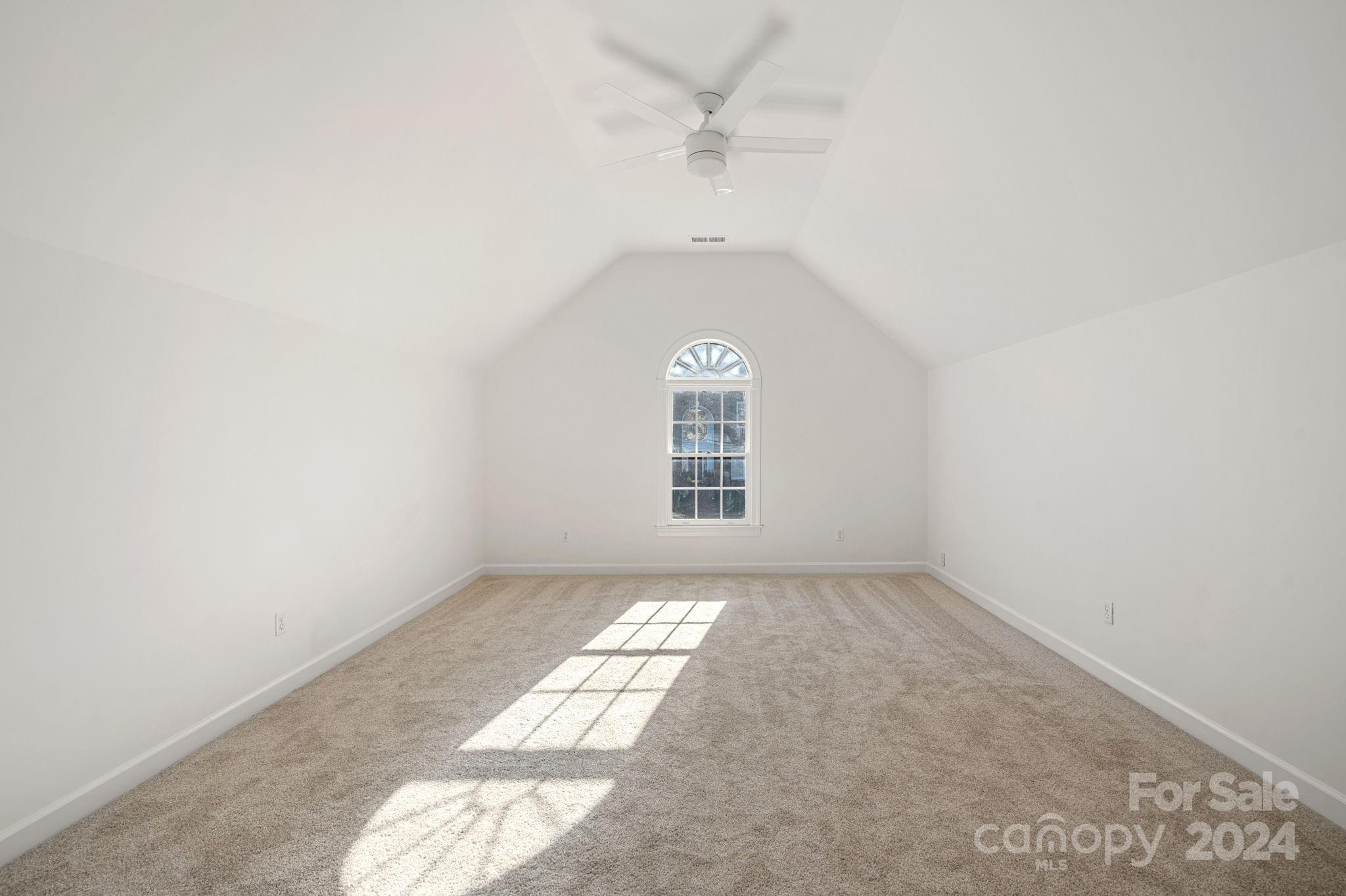 3425 Rhett Butler Place Charlotte, NC 28270 - Photo 32 of 48 an empty room with a white walls and a ceiling fan