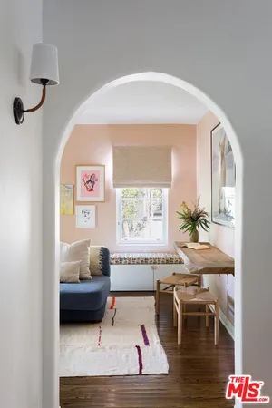 a room with a table chairs and wooden floor