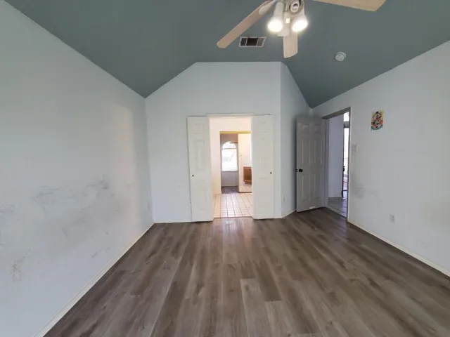 a view of a room with wooden floor and natural light