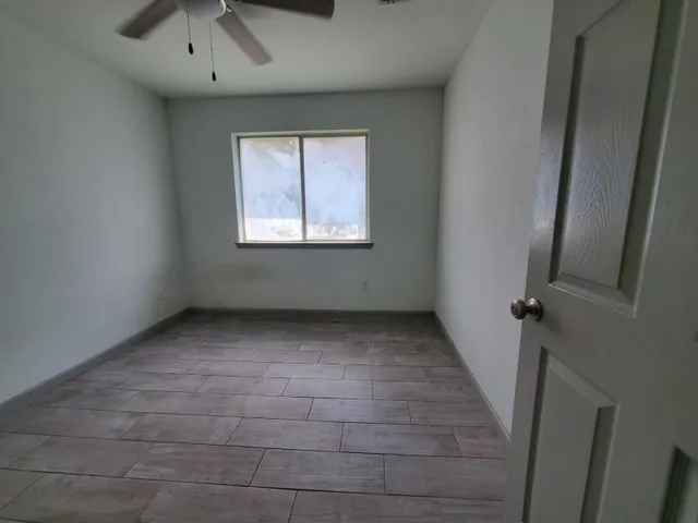 an empty room with a empty space and windows
