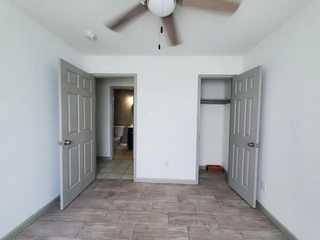 a view of a hallway with wooden shelves