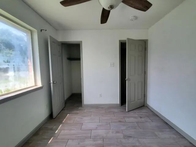 a view of an empty room with a window