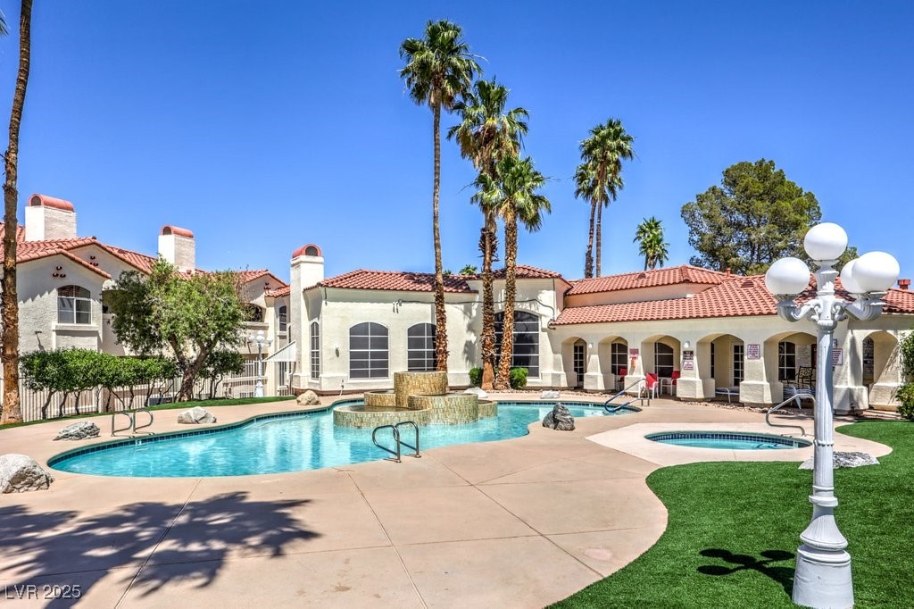 698 South Racetrack Road, Unit 1014 Henderson, NV 89015 - Photo 2 of 25 Community pool with a hot tub, a patio, and a yard