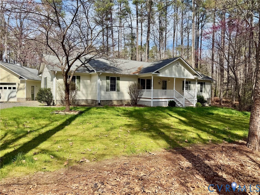 43 Ruddy Duck Road Heathsville, VA 22473 - Photo 38 of 46 a front view of a house with a yard table and chairs