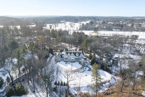 an aerial view of a city with lots of residential buildings and green landscape