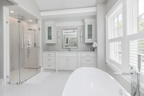 a bedroom with a bed and a large window