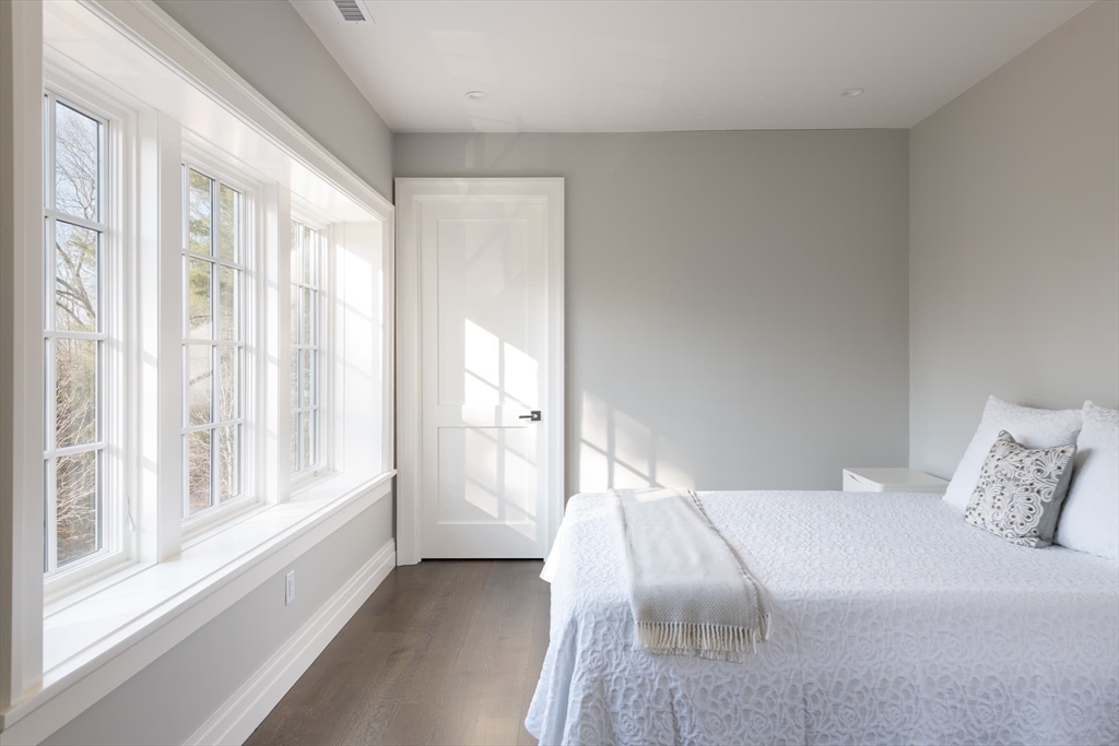 8 Hidden Road Weston, MA 02493 - Photo 26 of 42 a bedroom with a bed and a large window