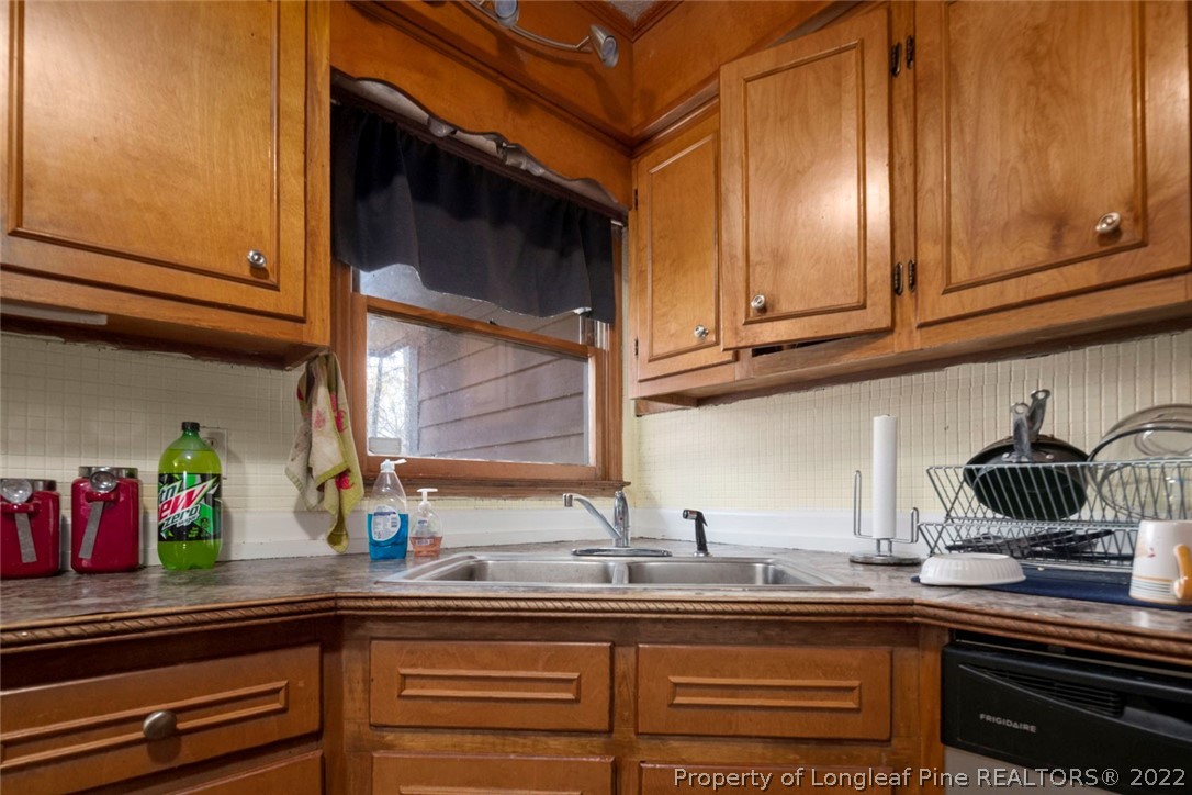 5011 Maxwell Road Autryville, NC 28318 - Photo 13 of 36 a kitchen with stainless steel appliances granite countertop a sink and cabinets