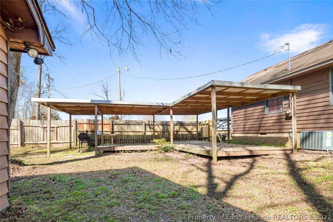 5011 Maxwell Road Autryville, NC 28318 - Photo 34 of 36 a view of a patio with a table and chairs