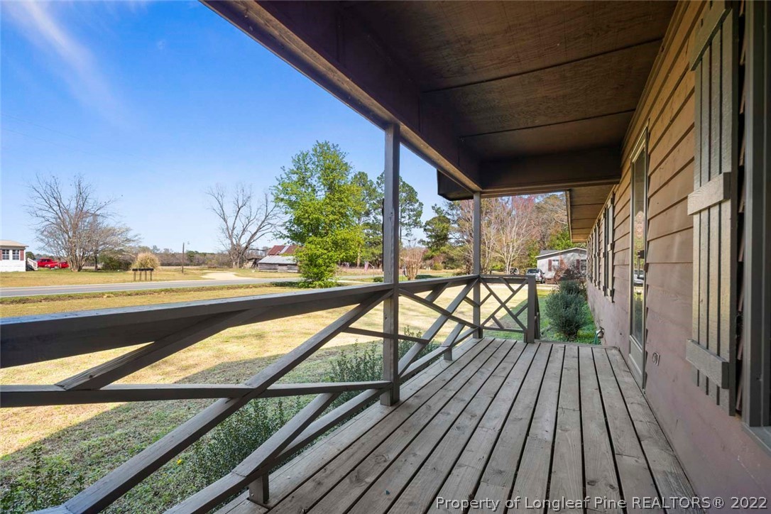5011 Maxwell Road Autryville, NC 28318 - Photo 5 of 36 a view of balcony with wooden floor and fence