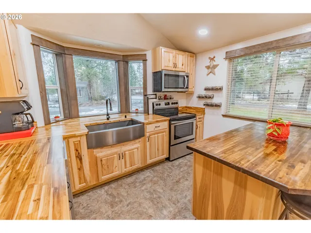 a kitchen that has a sink and a stove top oven