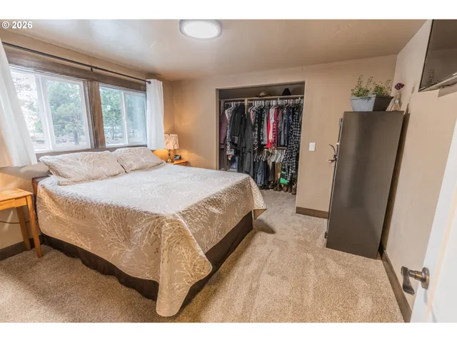 a bed sitting in a bedroom next to a window