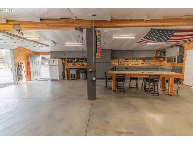 a view of a big room with table tennis table and chairs