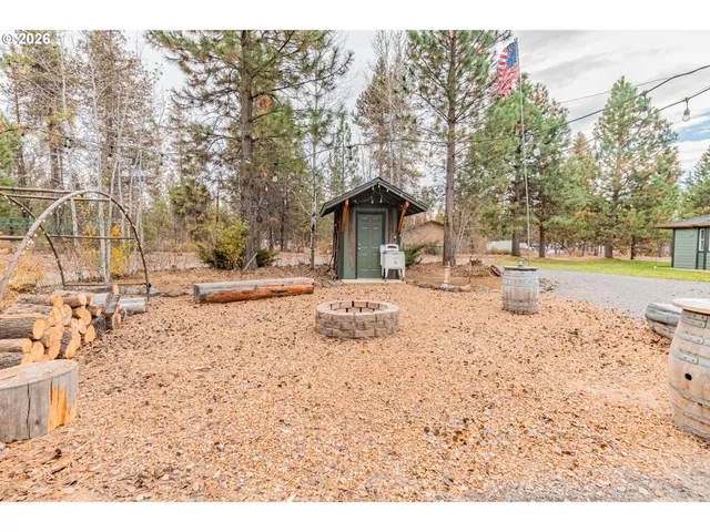 a view of a dry yard with snow on the road