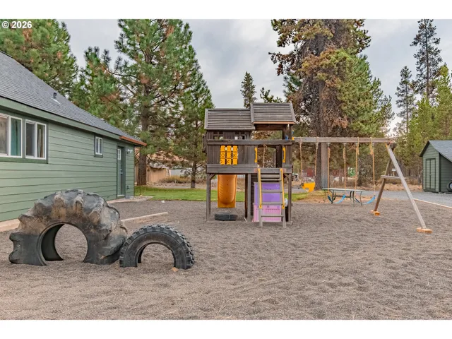a view of a house with a backyard and a garage