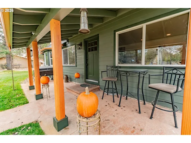 a view of a chairs and table in the balcony