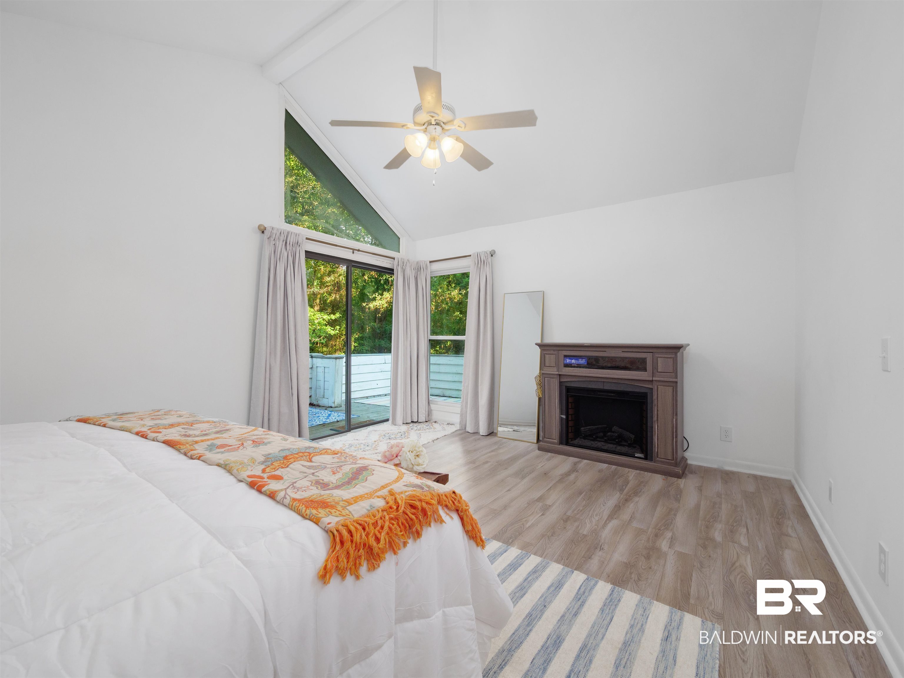 494 Ridgewood Drive Daphne, AL 36526 - Photo 23 of 40 Bedroom featuring access to exterior, beamed ceiling, light hardwood / wood-style flooring, high vaulted ceiling, and ceiling fan
