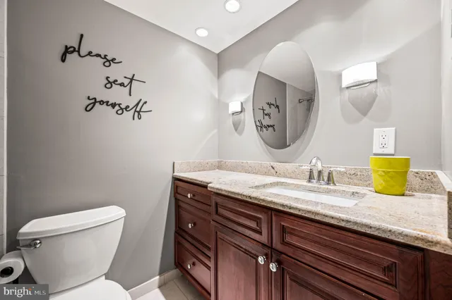 a bathroom with a toilet a sink and mirror