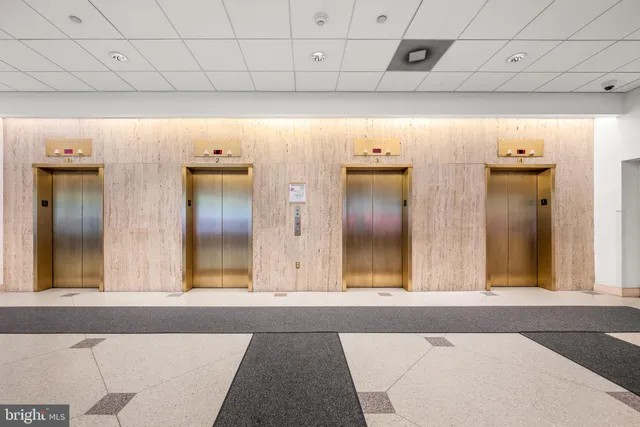 a view of a hallway with wooden floor and cabinet