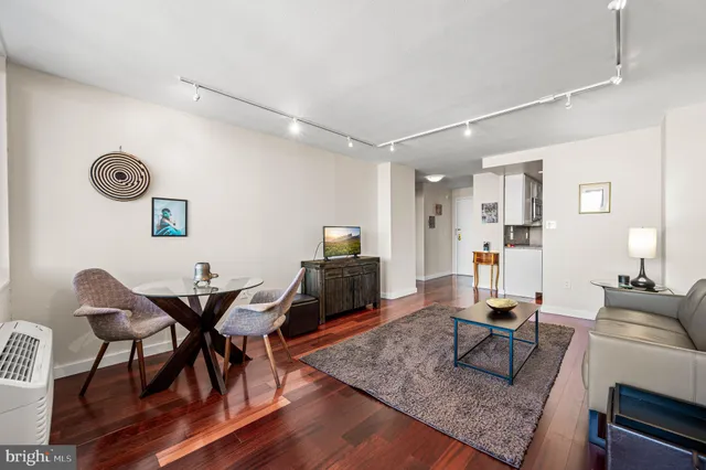 a living room with furniture and wooden floor