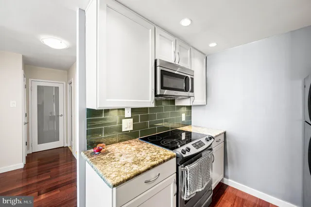 a kitchen with a stove and a microwave