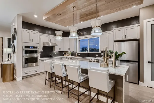 a kitchen with stainless steel appliances granite countertop a stove and a refrigerator