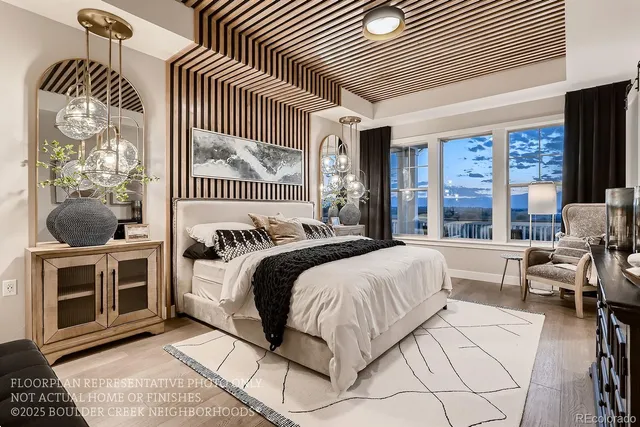 a spacious bedroom with a bed a dresser and potted plant