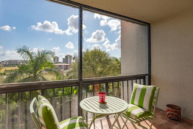 a view of a balcony dining table and chairs