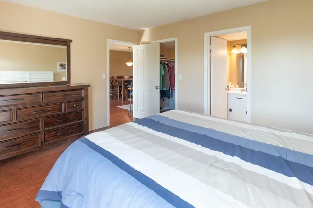 a bedroom with a bed and a dresser