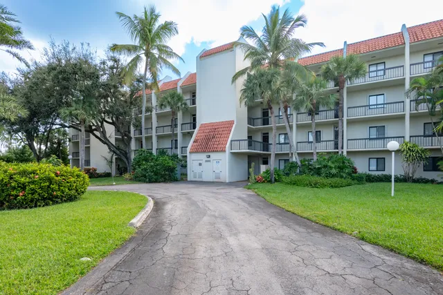 a front view of a house with a garden and yard
