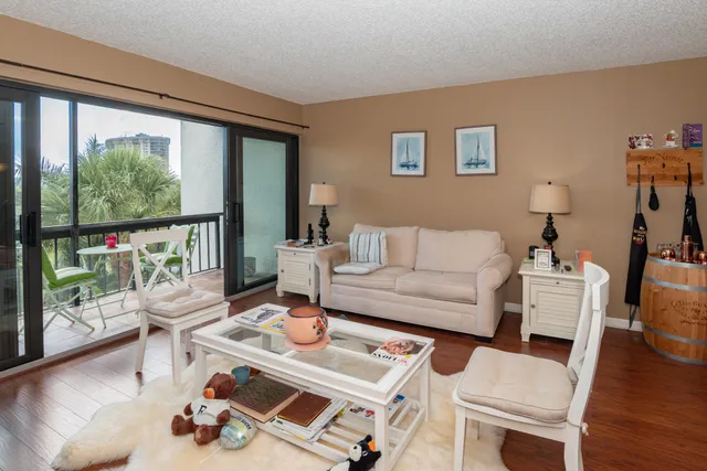 a living room with furniture and a floor to ceiling window