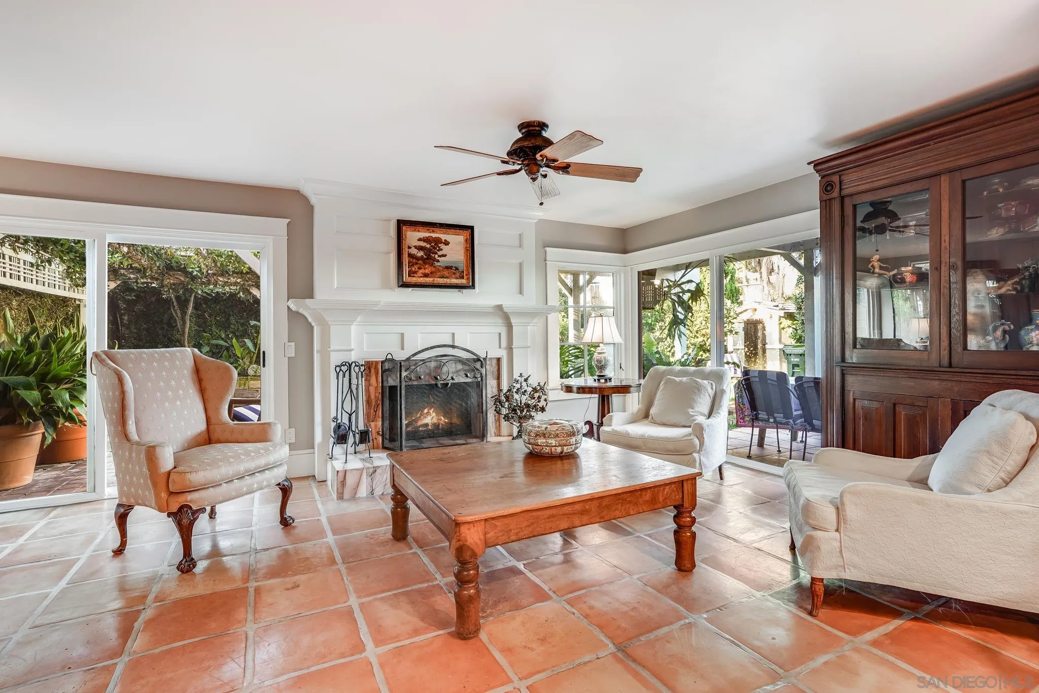 a living room with furniture a table and a fireplace