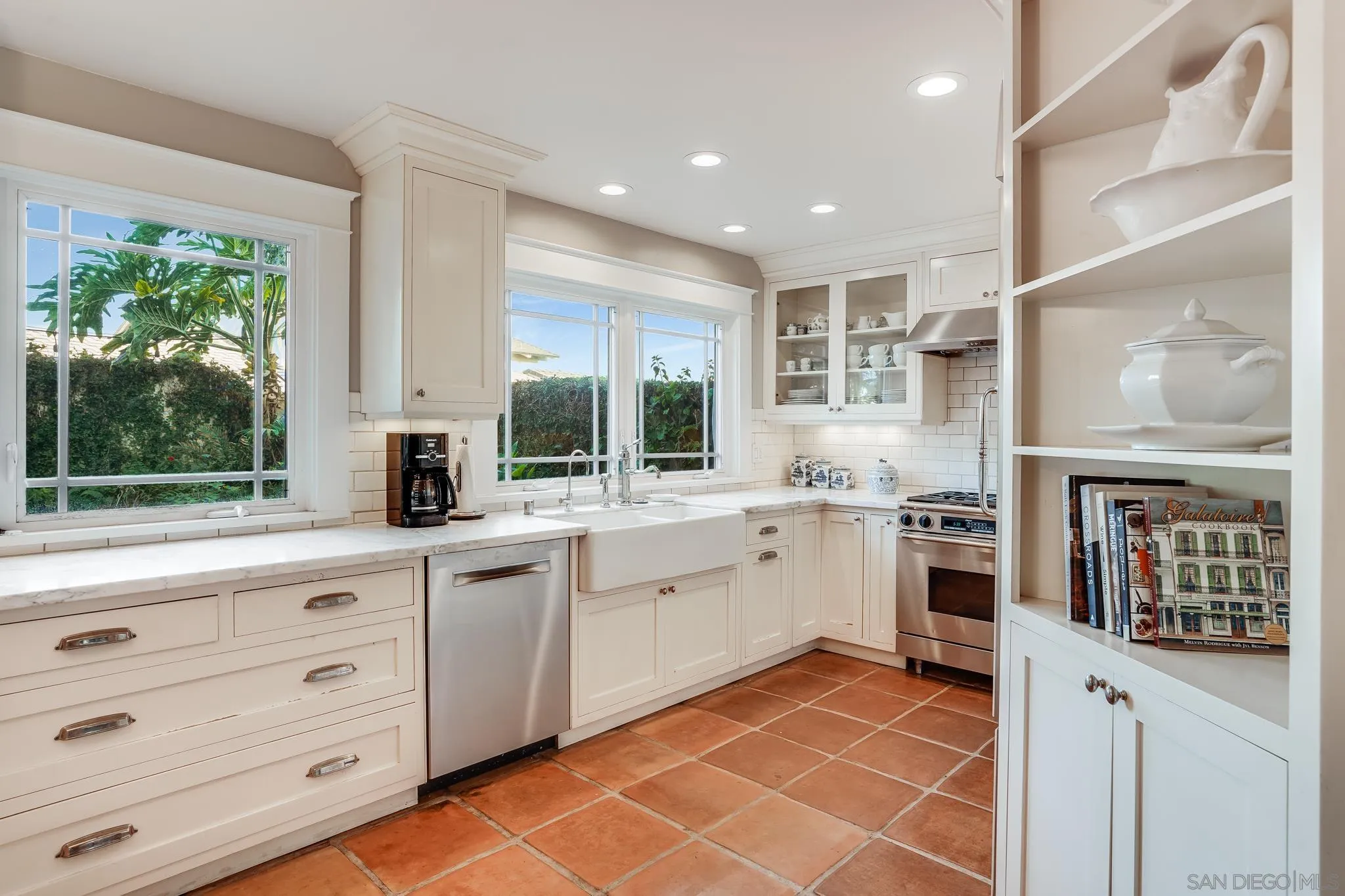 2 The Inlet Coronado, CA 92118 - Photo 13 of 40 a kitchen with a sink stove and cabinets