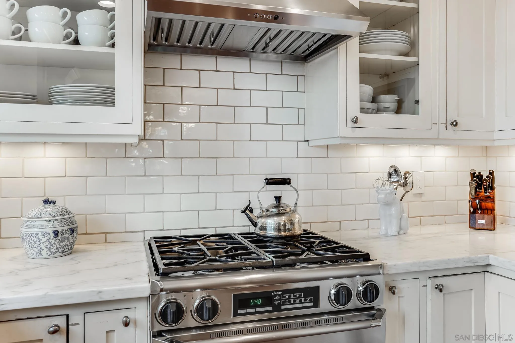 2 The Inlet Coronado, CA 92118 - Photo 14 of 40 a stove top oven sitting inside of a kitchen
