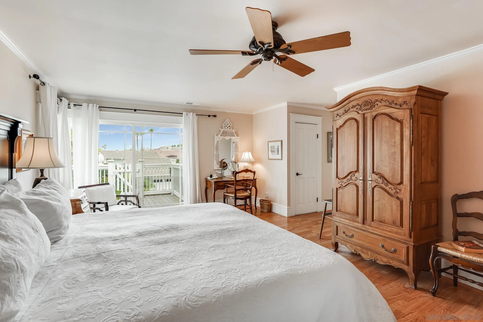 2 The Inlet Coronado, CA 92118 - Photo 18 of 40 a bedroom with a bed a ceiling fan and a large window
