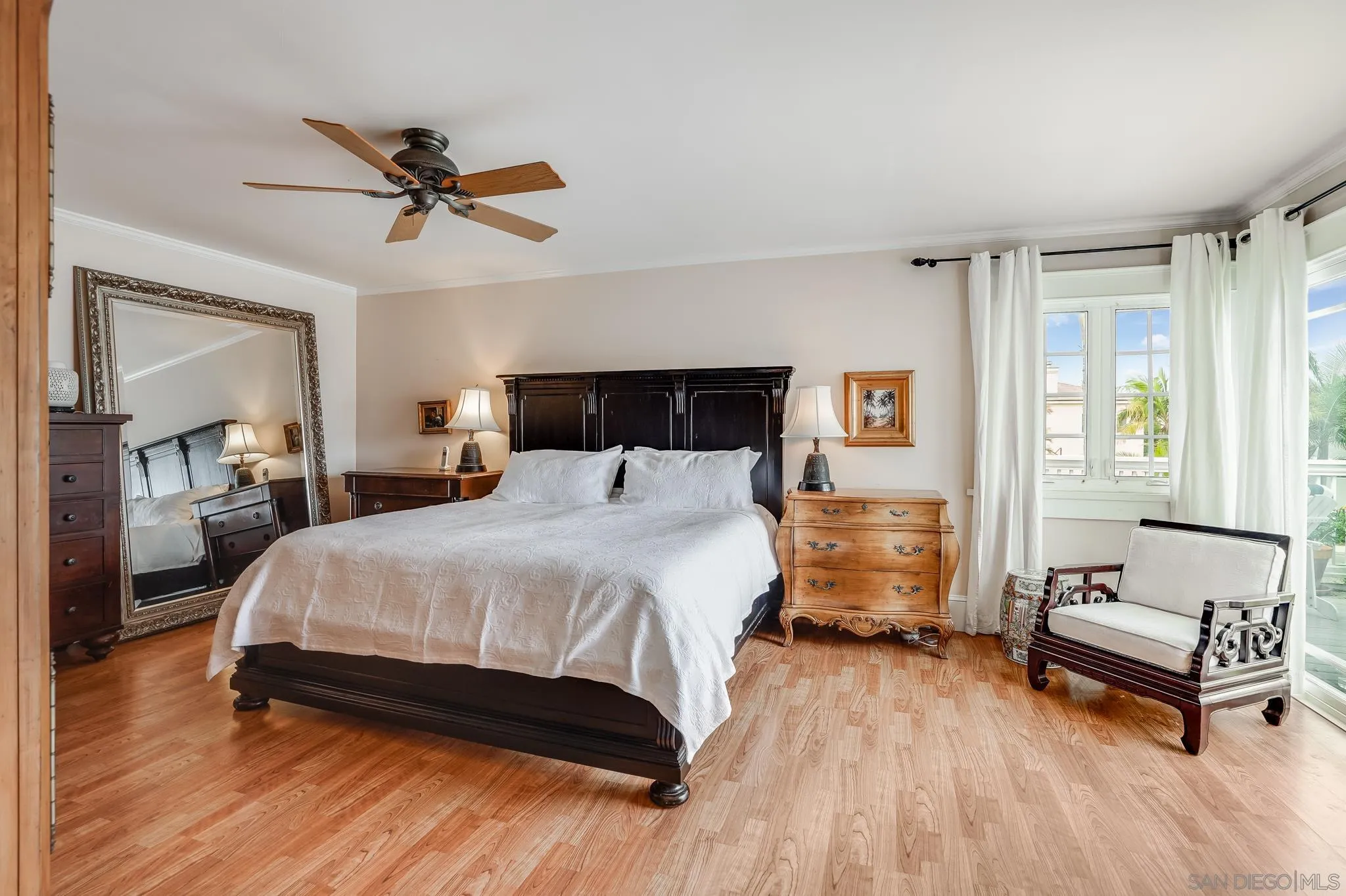 2 The Inlet Coronado, CA 92118 - Photo 19 of 40 a bedroom with a bed and wooden floor