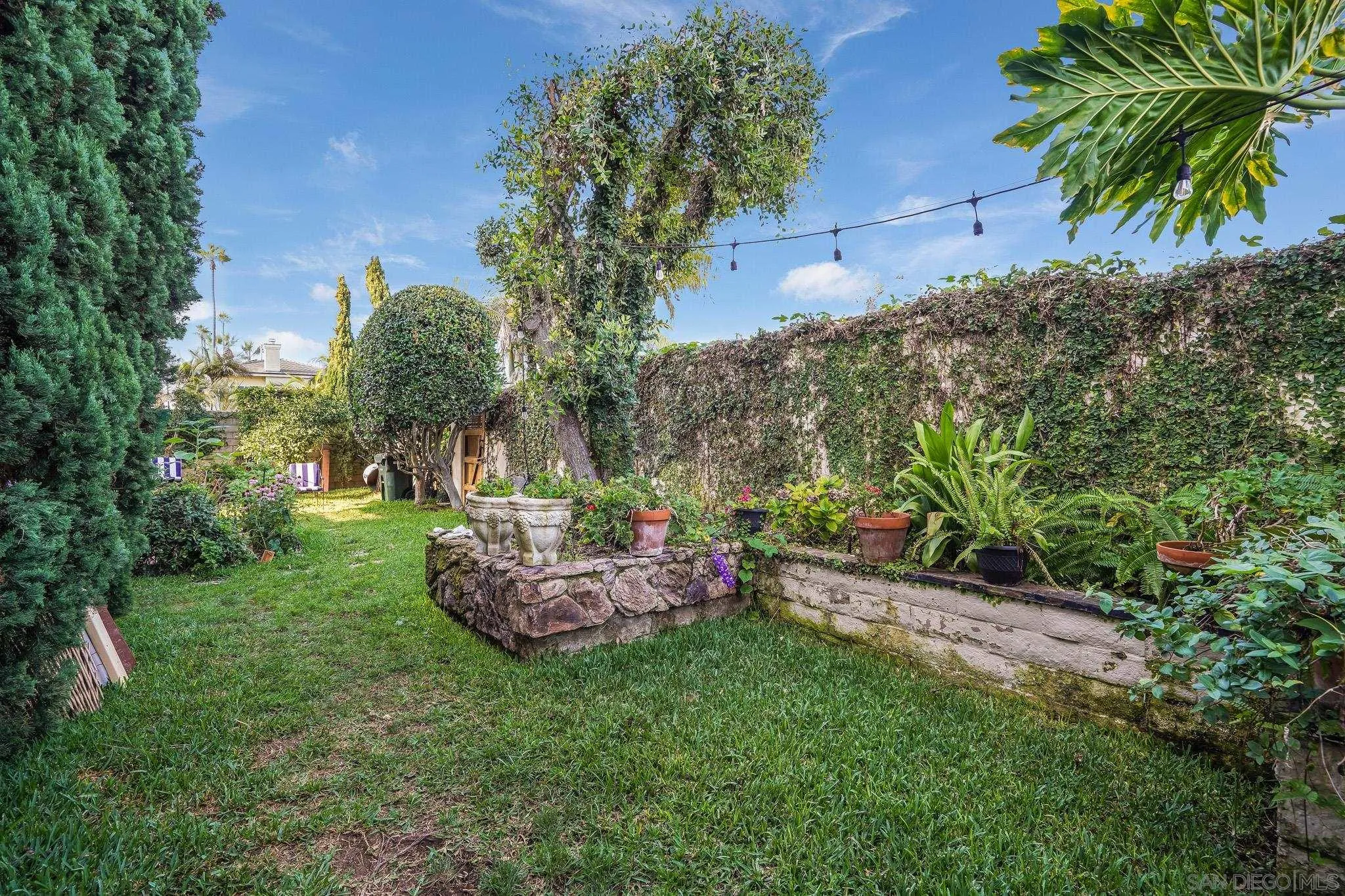 2 The Inlet Coronado, CA 92118 - Photo 37 of 40 a view of a backyard with plants and a garden