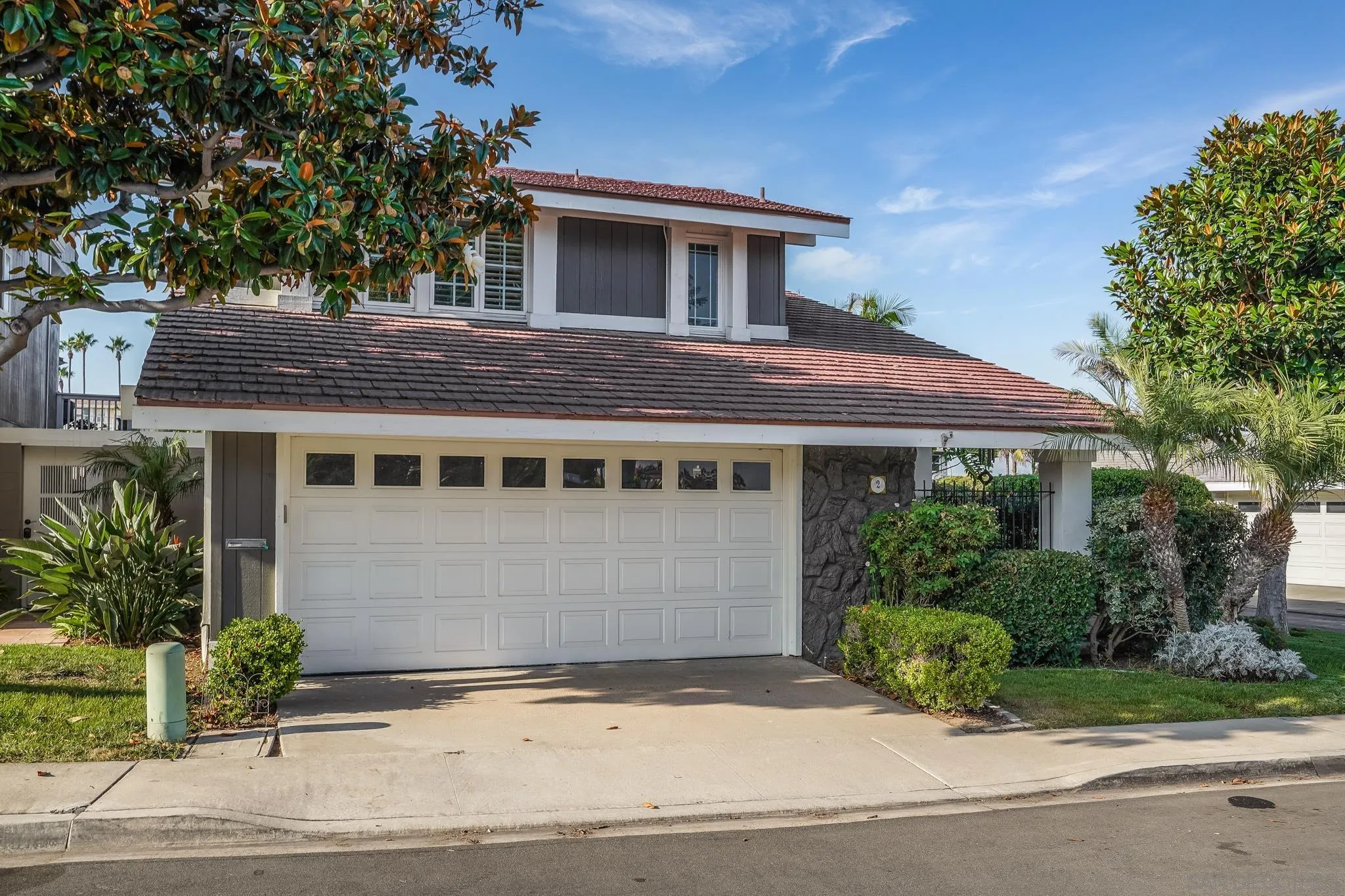2 The Inlet Coronado, CA 92118 - Photo 39 of 40 a front view of a house with a garden